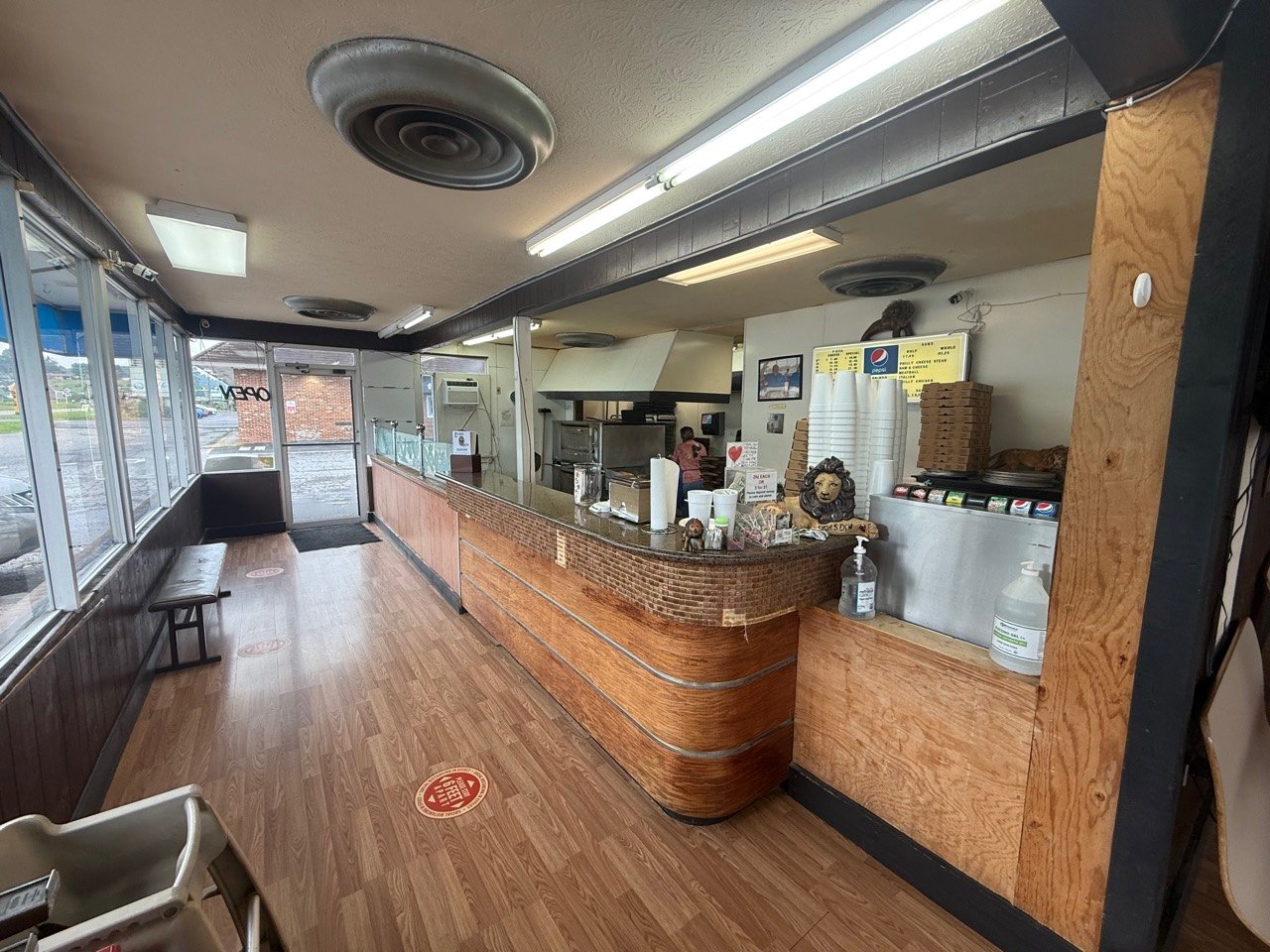 The counter and open kitchen inside Lyon's Den Pizza