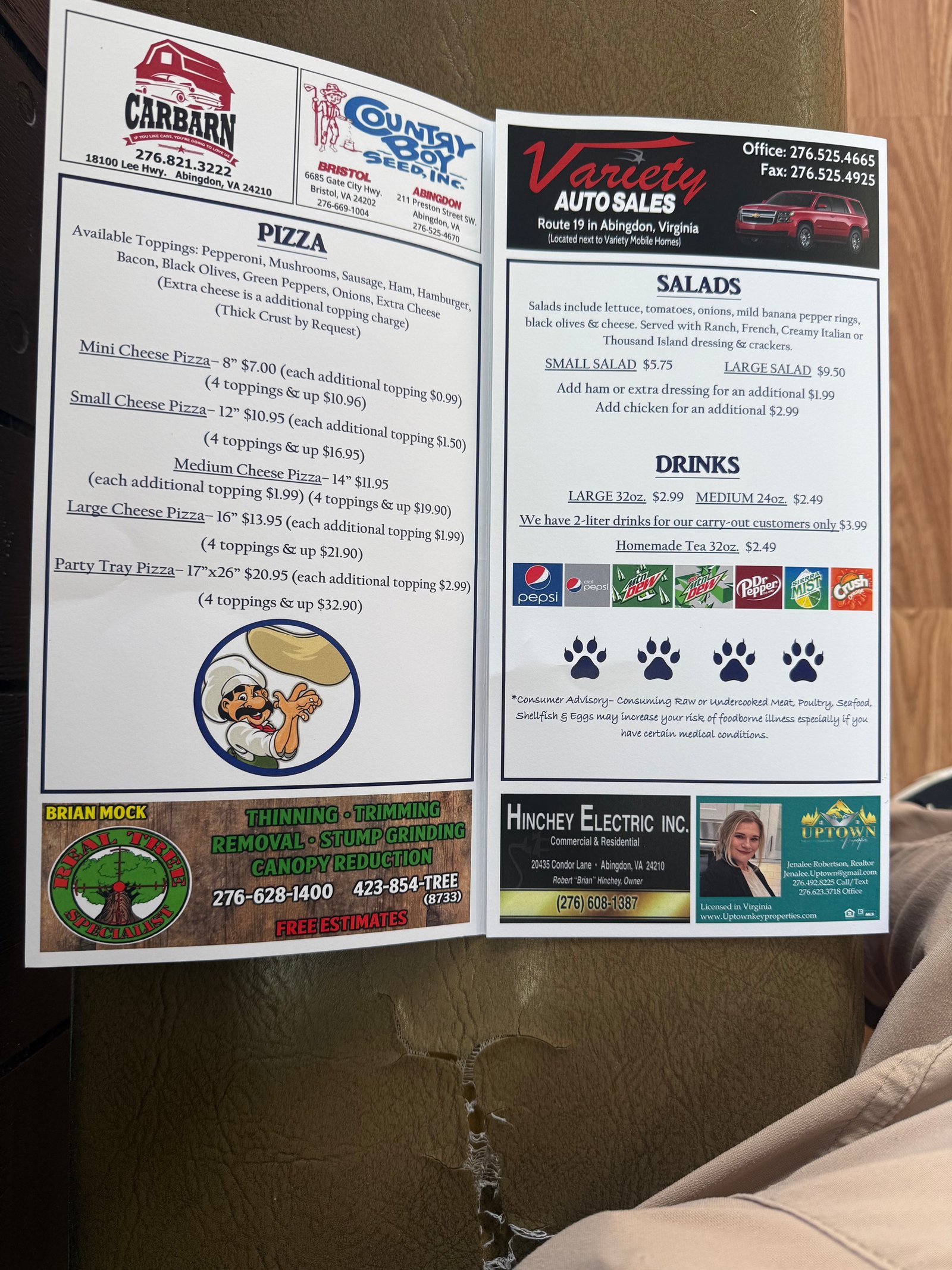 Printed Lyon's Den menu showing pizza, salads, and drinks